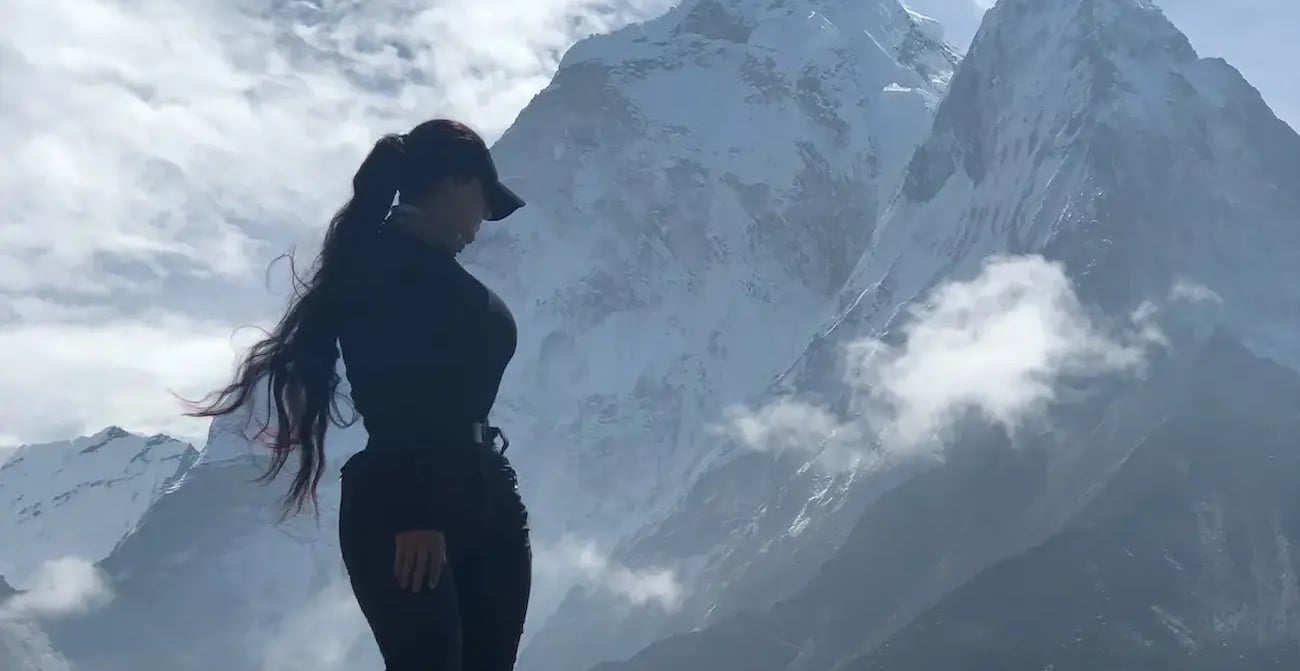 Mais Alhajri silhouette standing on mountain peak background