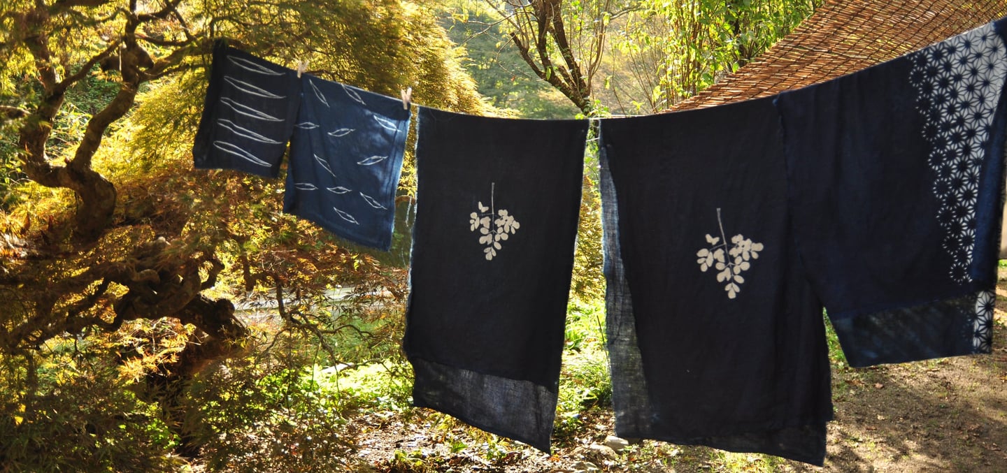 Traditional Japanese landscape view, blue indigo katazome fabrics hanging at the front