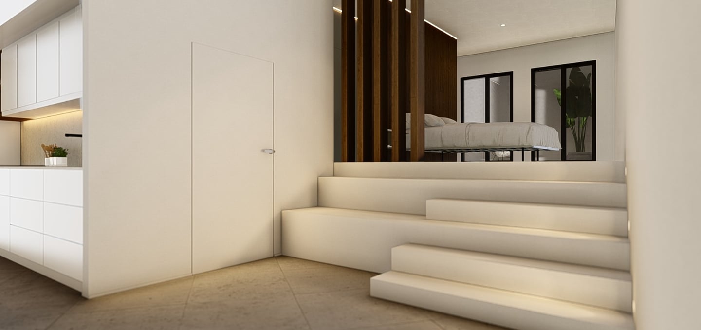 a modern home with a large white kitchen and stairs