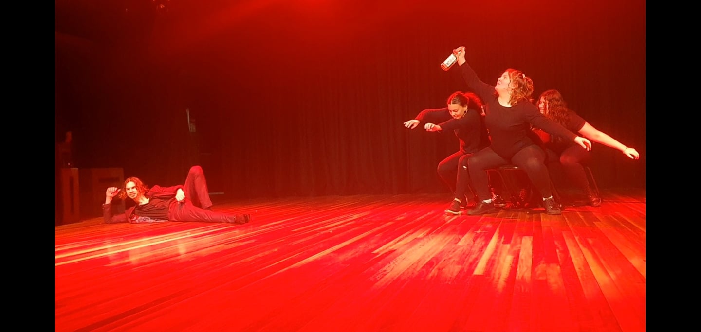 a group of dancers performing on stage