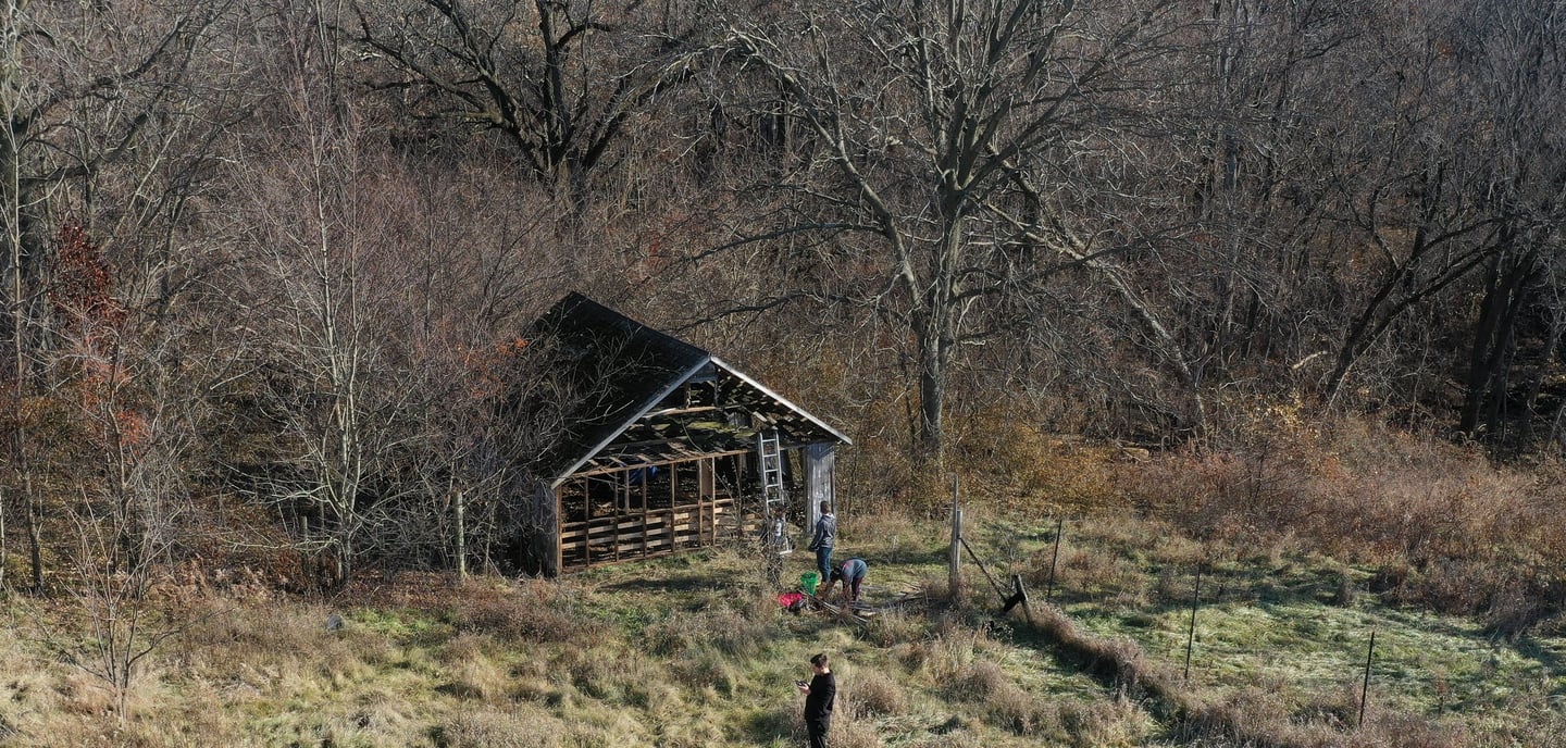 An aerial drone photo of an abandoned and decaying wood structure