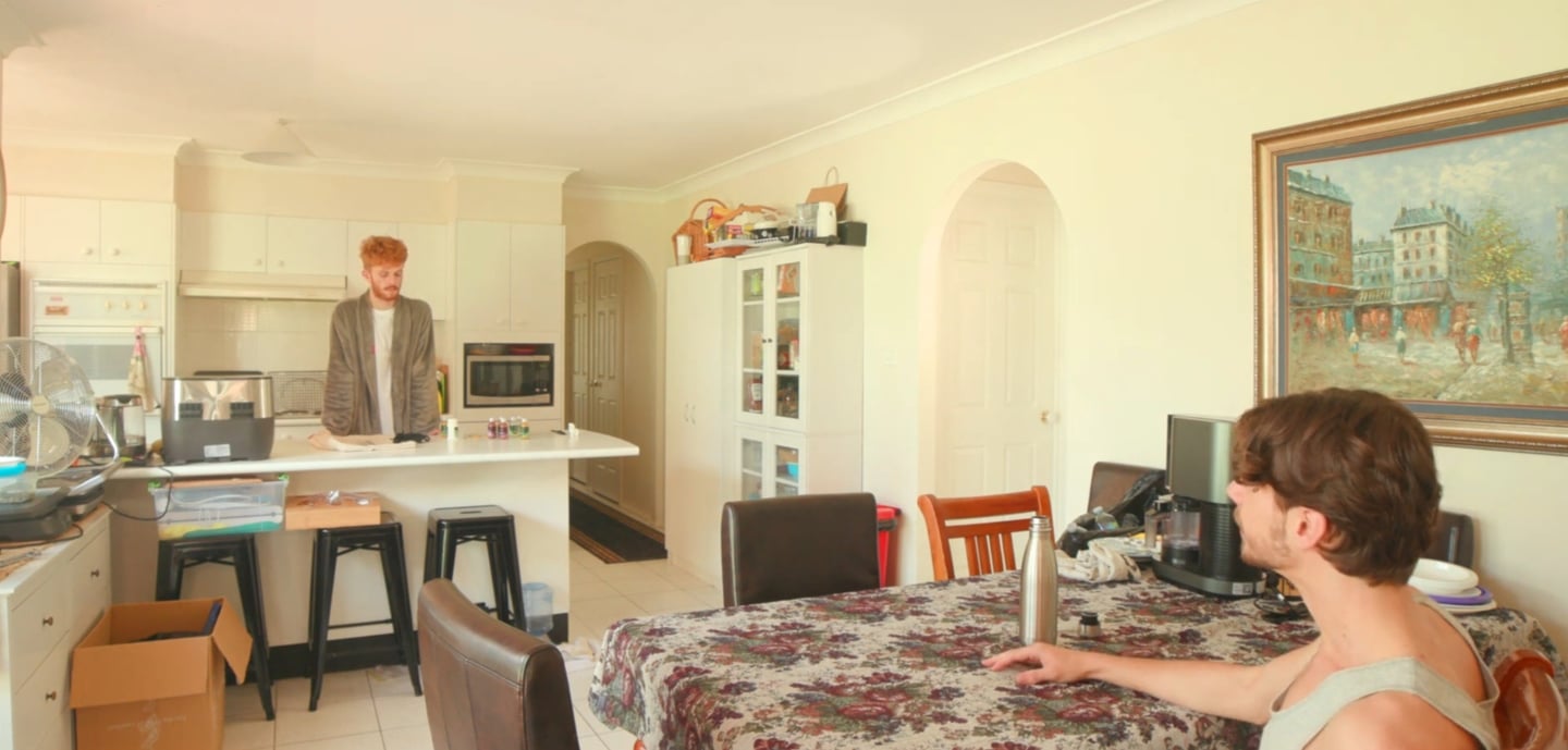 a man sitting at a table with a laptop computer