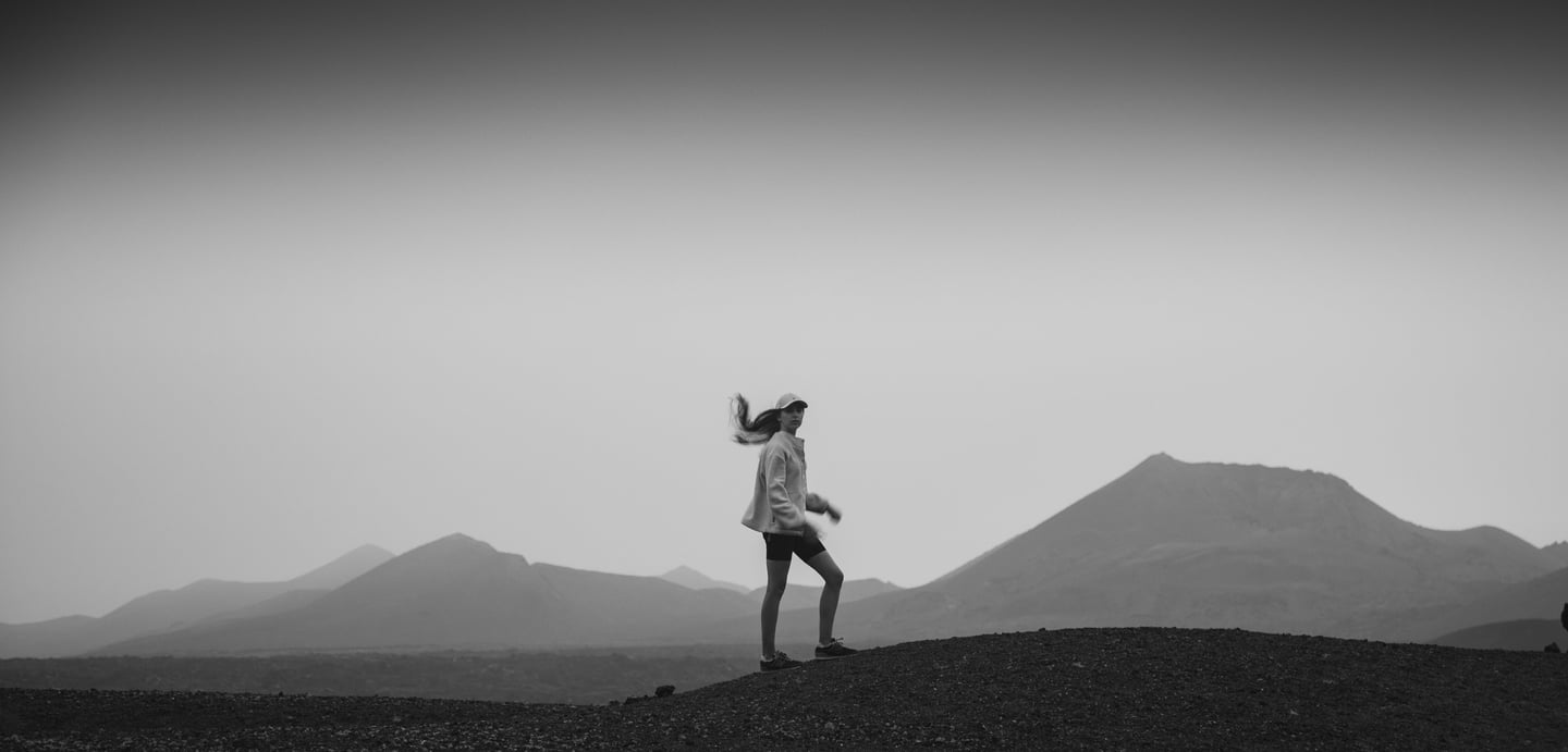 a woman standing in a lava field