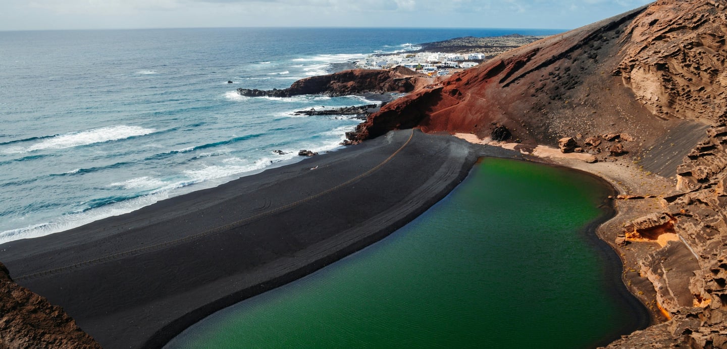 Lanzarote (Spain) a land carved over the Atlantic on fire and lava (photo by JP Files on Unsplash).