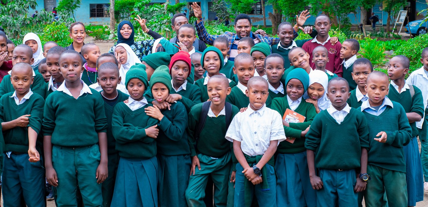 a group of children and adults posing for a group photo
