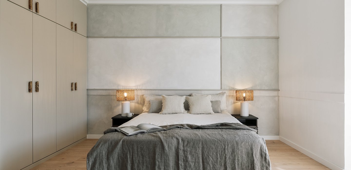 Elegant bedroom with subtle wall art, and calm beige tones, designed by SAVIA in Barcelona