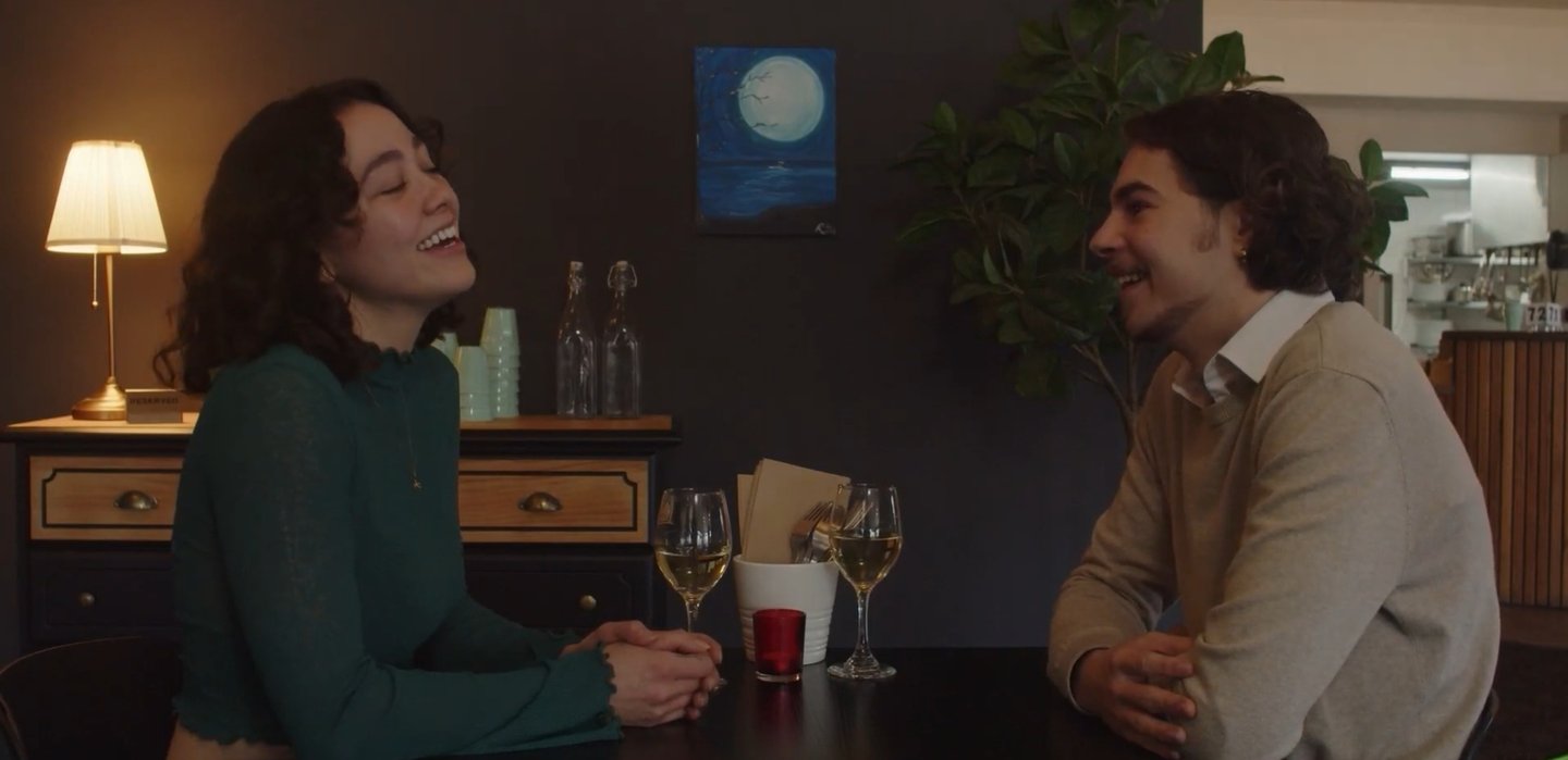 a man and woman sitting at a table