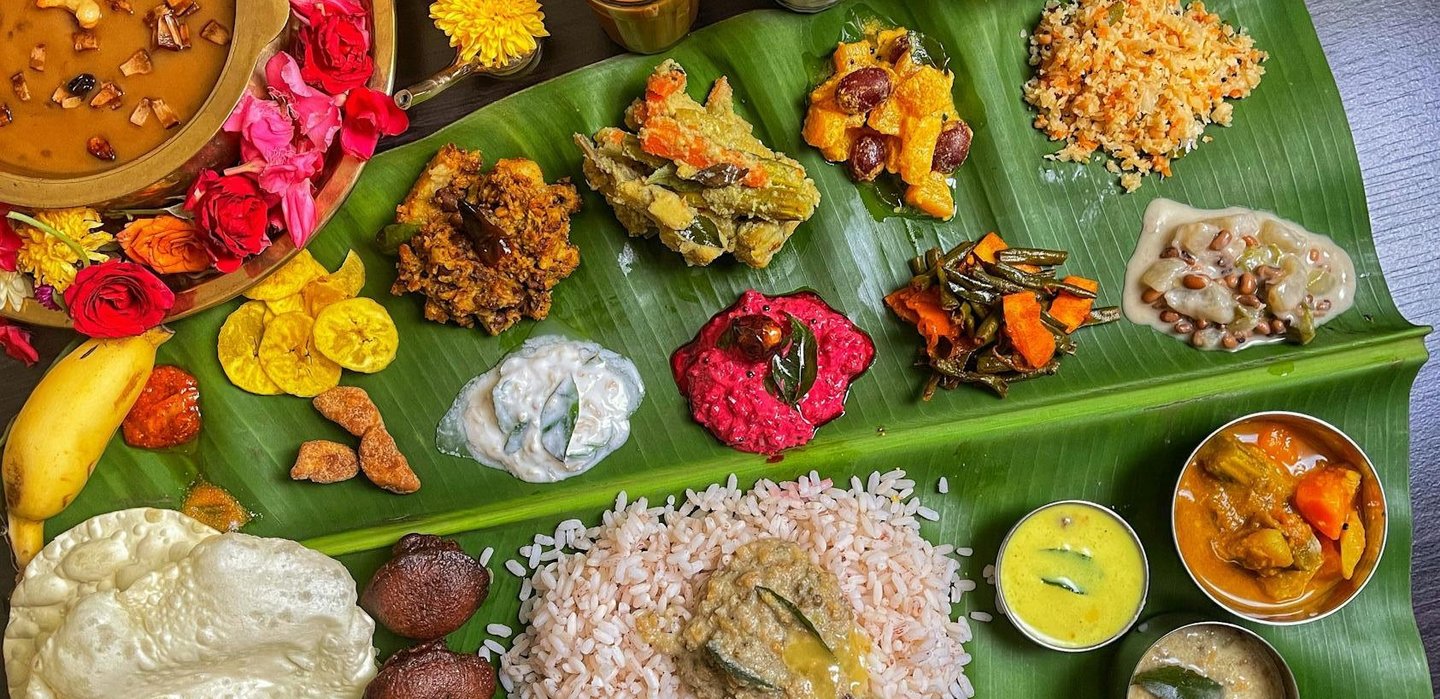 A full Kerala Sadhya featuring 20–28 vegetarian dishes.
