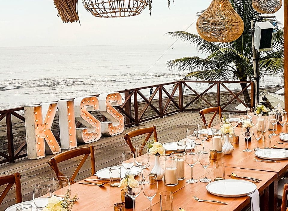 wedding reception set up with a light up sign that says "kiss"