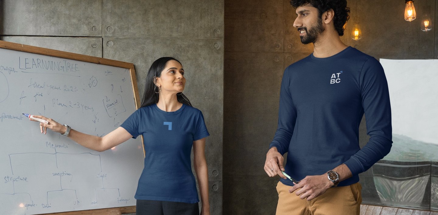 a man and woman standing in front of a white board board