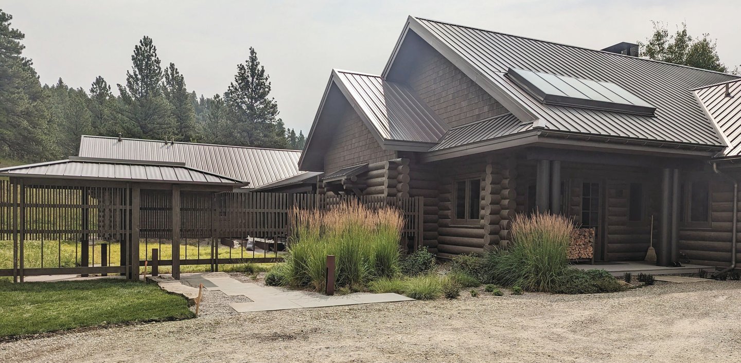 a log cabin with a metal roof