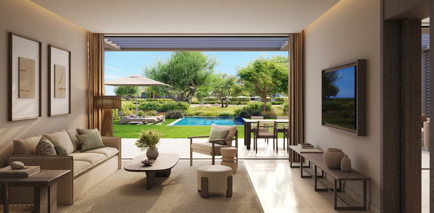 Modern luxury living room opening to a private patio with a swimming pool and lush garden view.