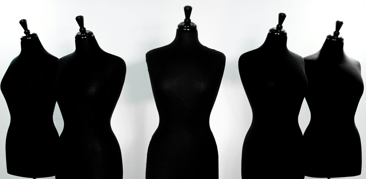 Row of silhouette mannequins