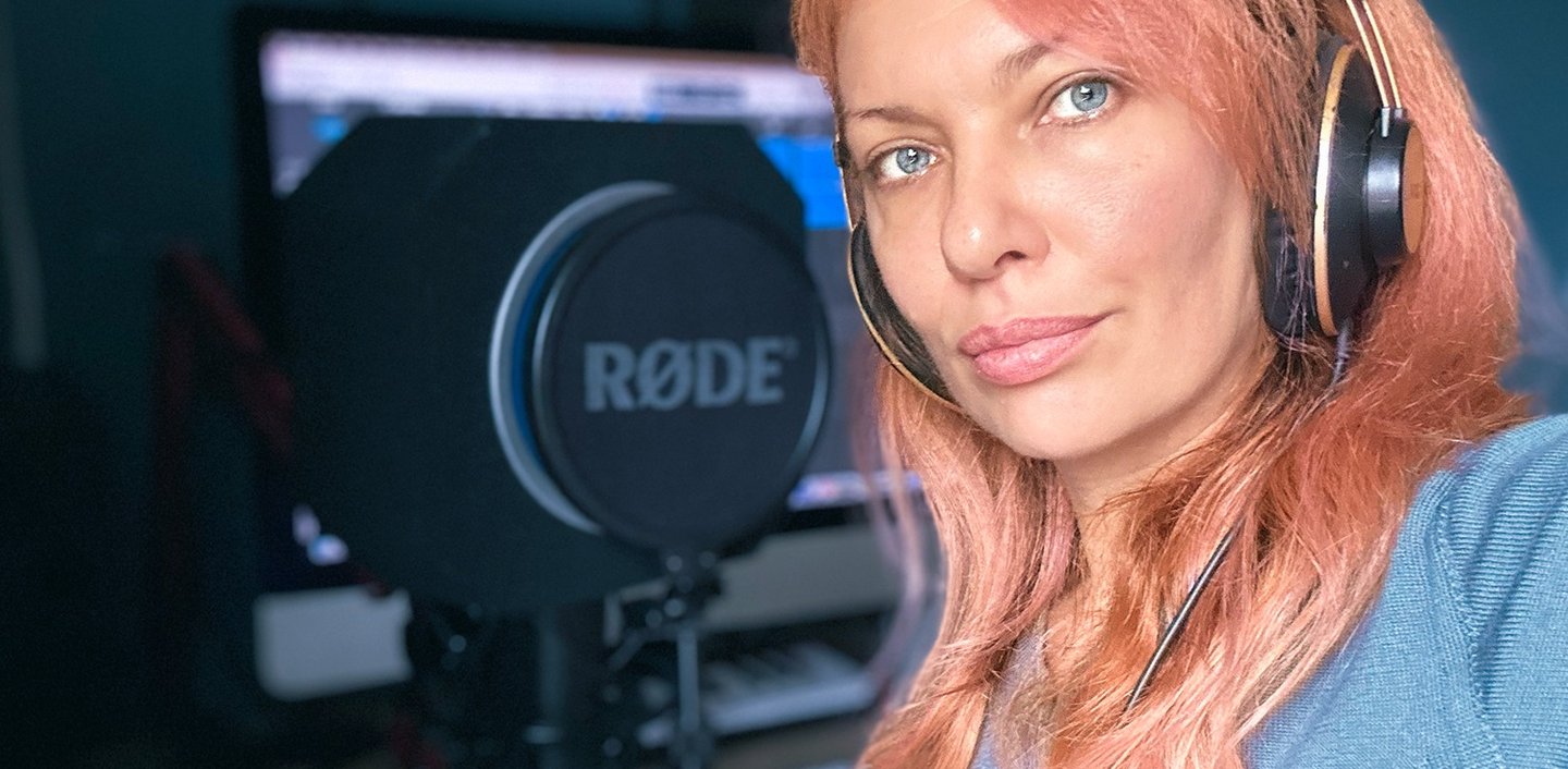 a woman with headphones and headphones on a microphone