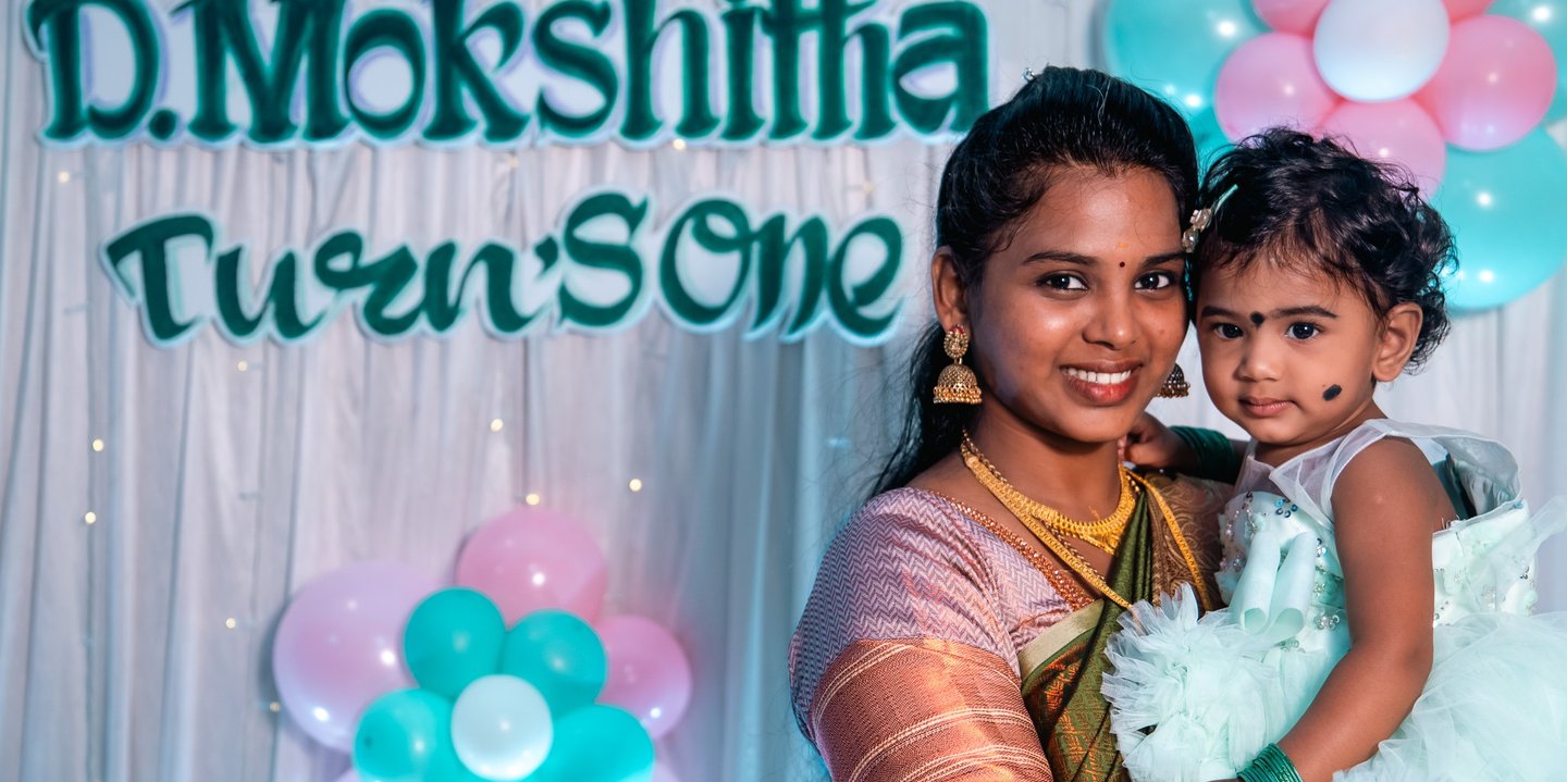 a woman holding a baby in her arms