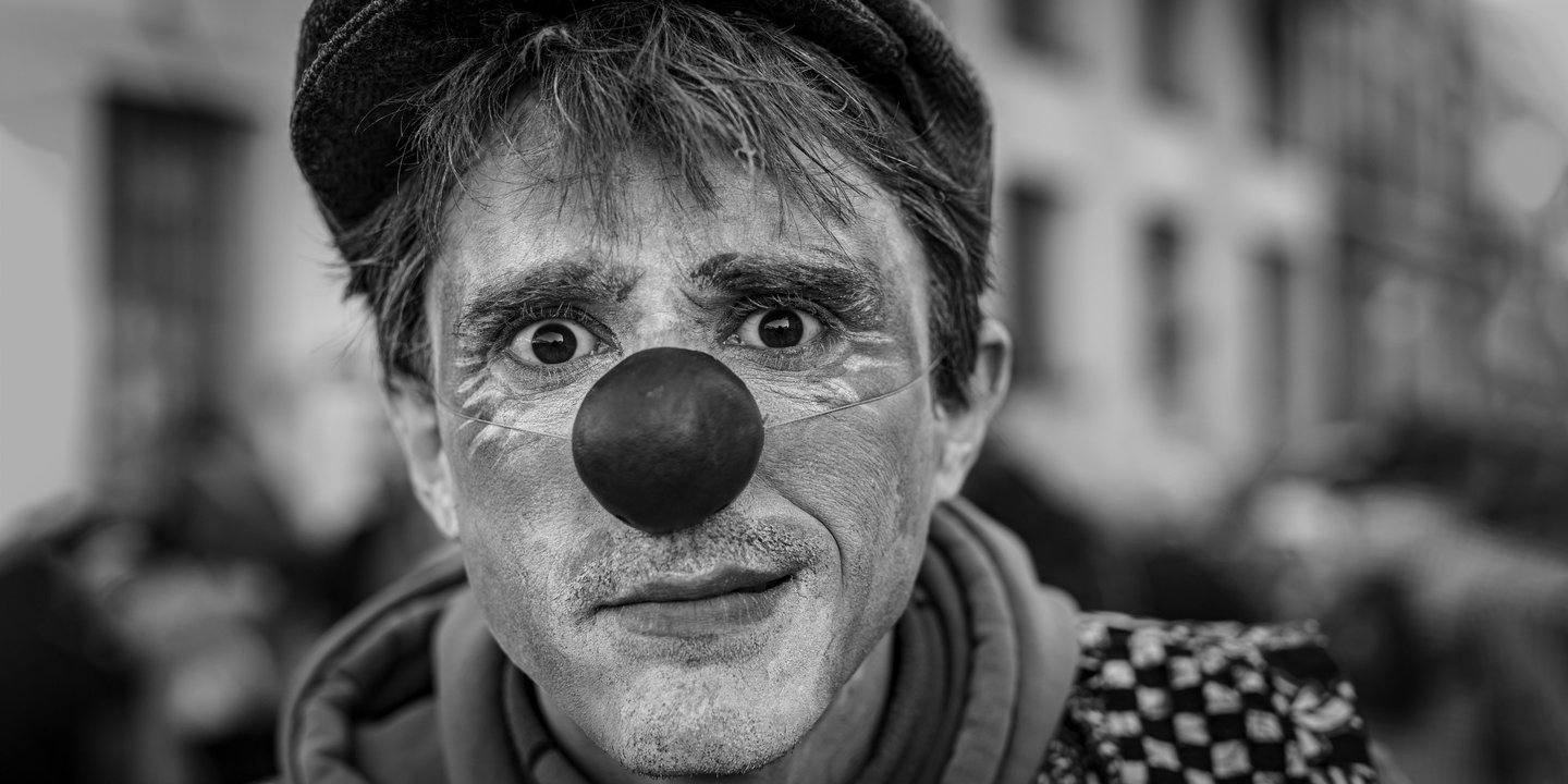a man with a clown nose and nose paint on his face