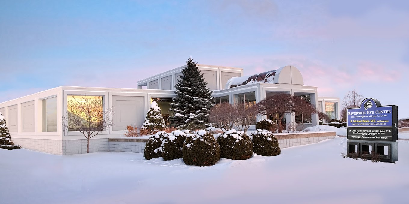 office building with snow covered trees