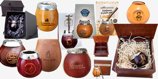 A collection of yerba mate gourd sets and bombilla straws in decorative gift boxes.