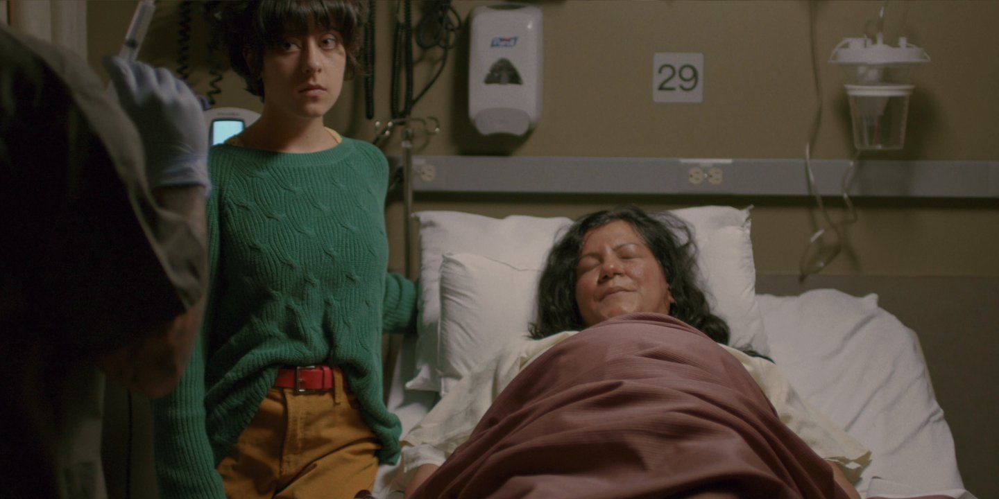 a man with dreadlocks and dreadlocks standing in front of a window