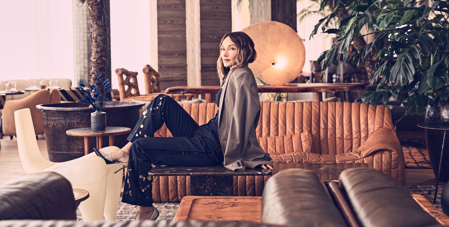 Kelly Wearstler in a modern lounge with warm leather seating.