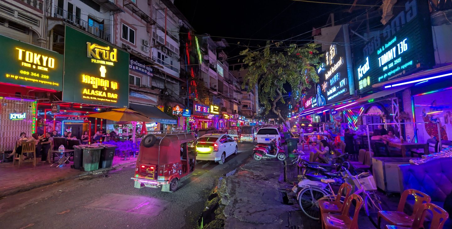 a neon lit night street scene in Phnom Penh, Cambodia