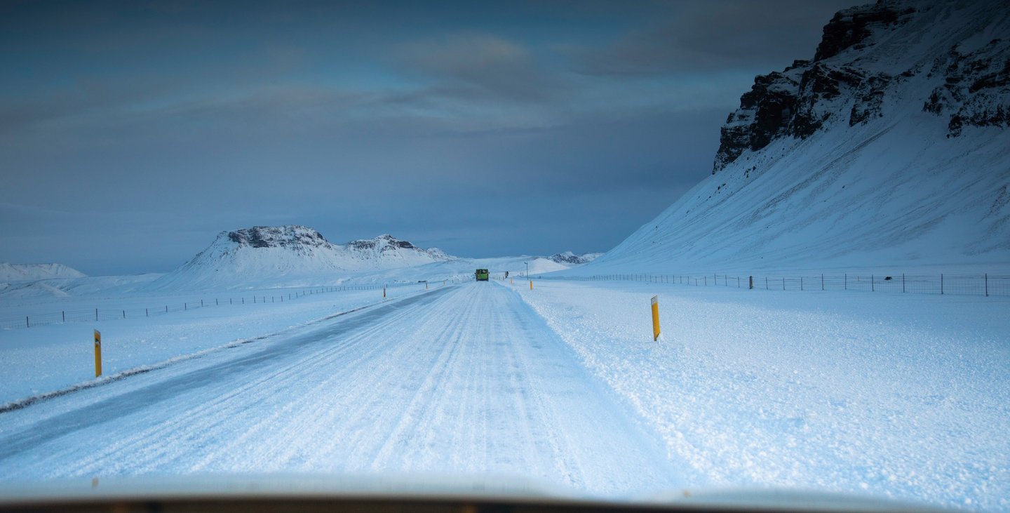 a car driving down a snowy road