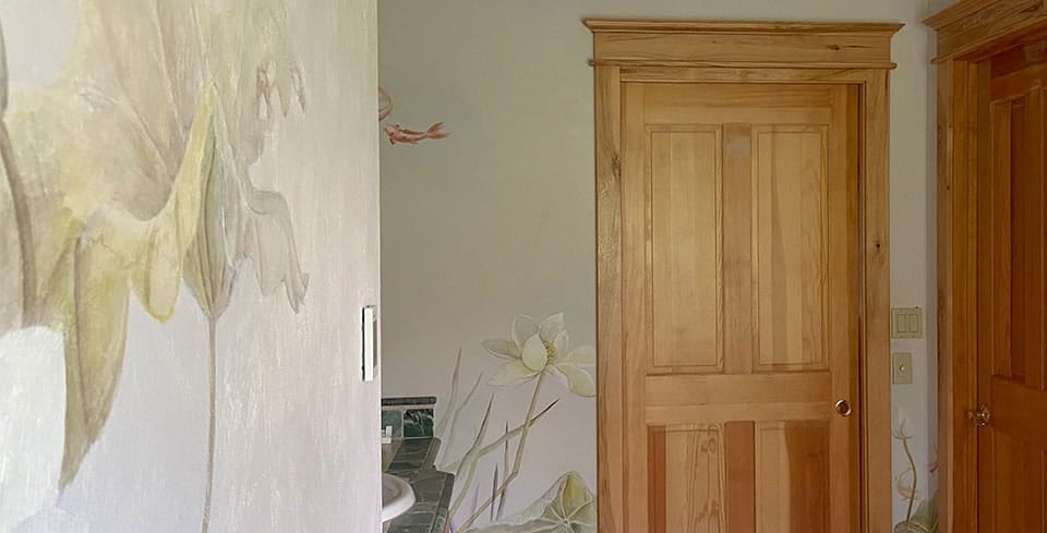 Luxury bathroom featuring painted murals of water lilies, koi and dragonflies in watercolour and an Asian touch