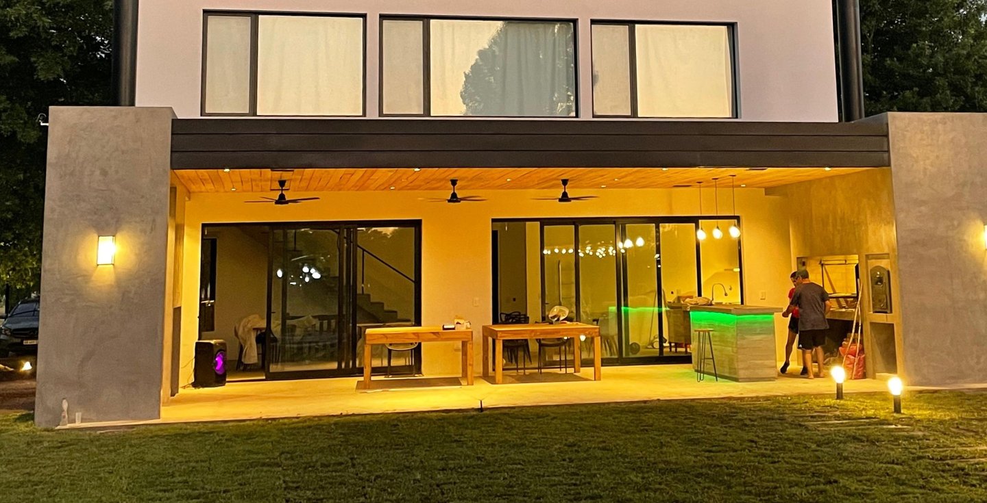 a house with a large backyard area and a patio area