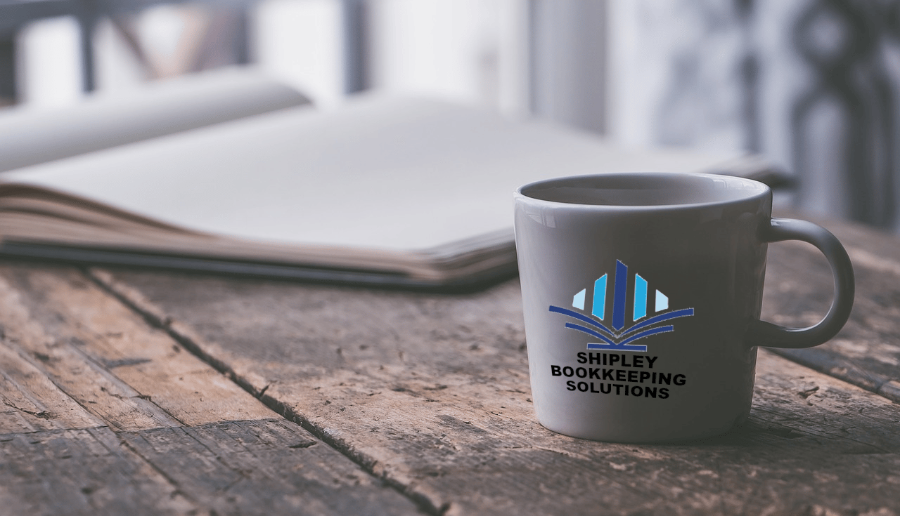 a Shipley Bookkeeping Solutions coffee mug mug with a journal