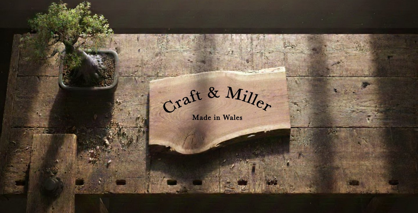craft and miller sign on a wooden workbench with a bonsai in the corner