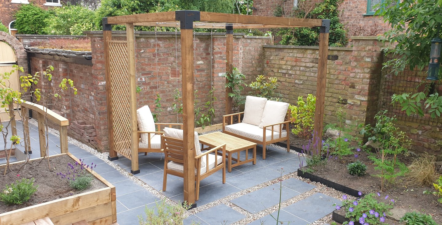 A Pergola with seats under it from a garden design by the intrinsic link