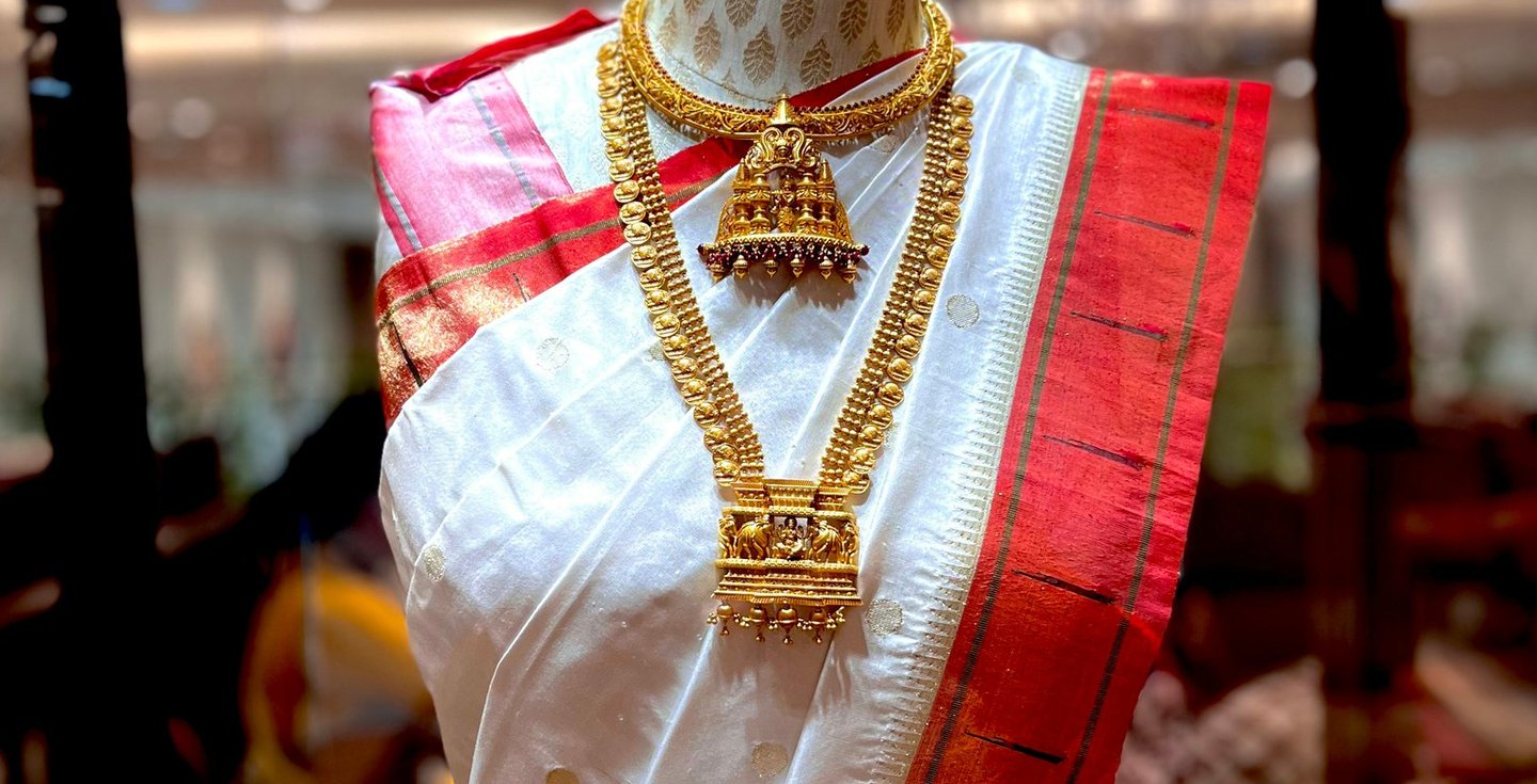 A mannequine of a woman's dress and a necklace.