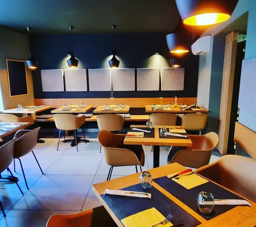 Salle de restaurant italien à Schiltigheim avec des tables dressées, des chaises confortables