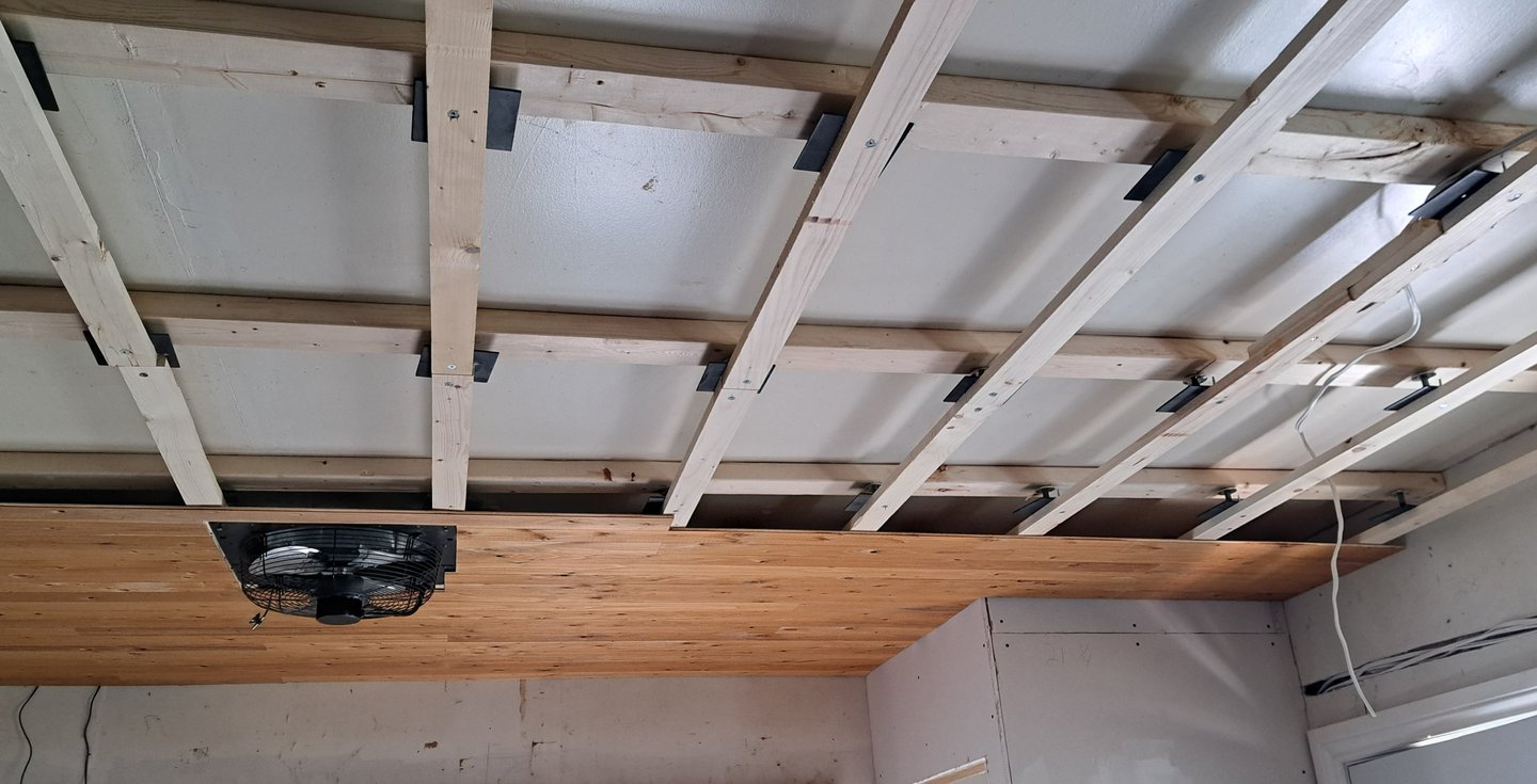 Wood ceiling framing installation in progress for residential levelling renovation project in Canada