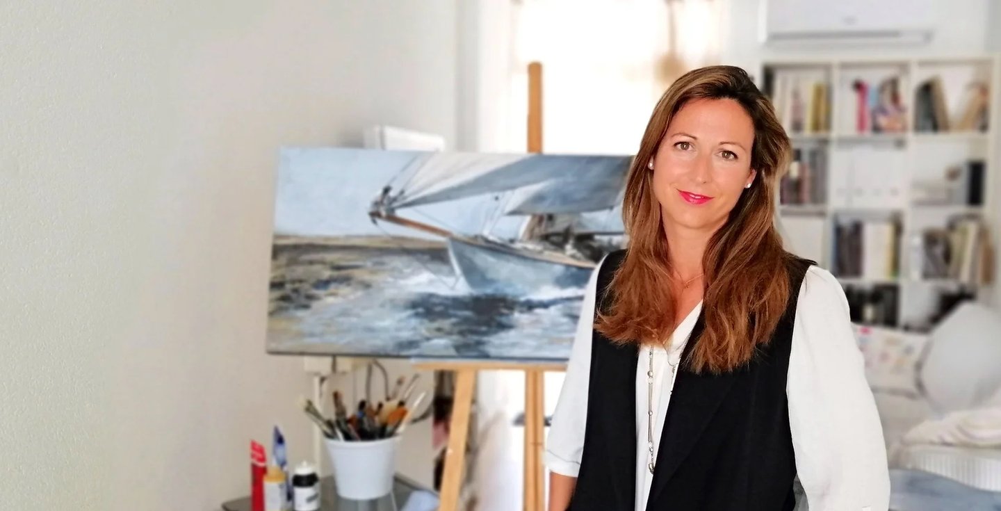a woman standing in front of a painting
