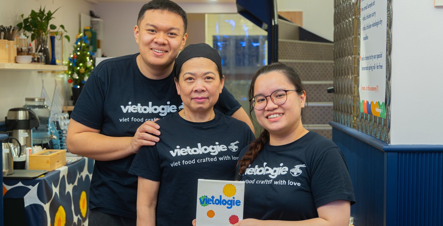 a team of 3 founders in uniform posing in a restaurant