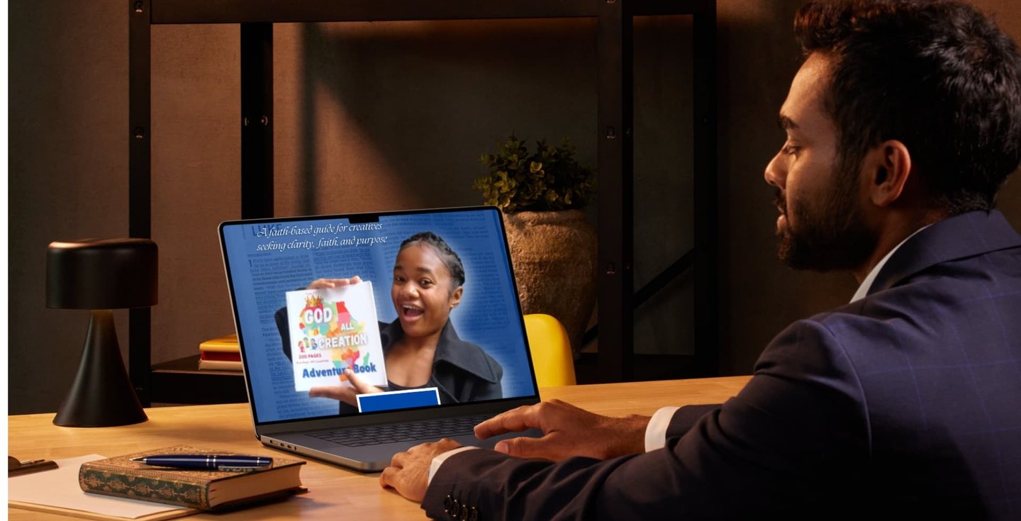 Man watching a video about a faith-based adventure book on his laptop in a cozy office setting.
