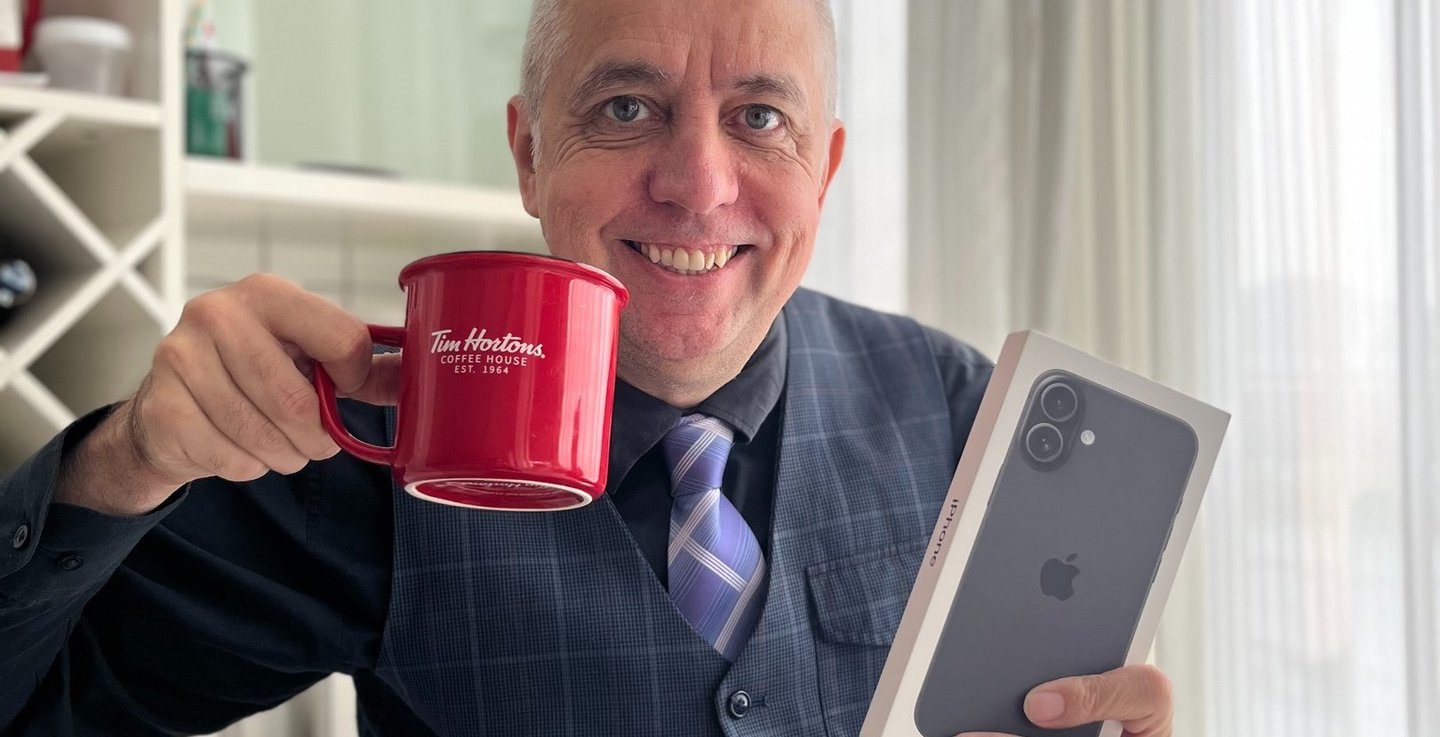 a man in a suit and tie holding a cup of coffee