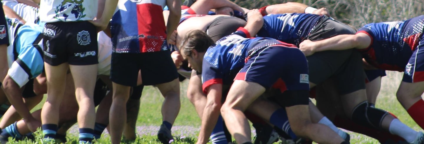 a group of people playing a game of rugby scrum maul 