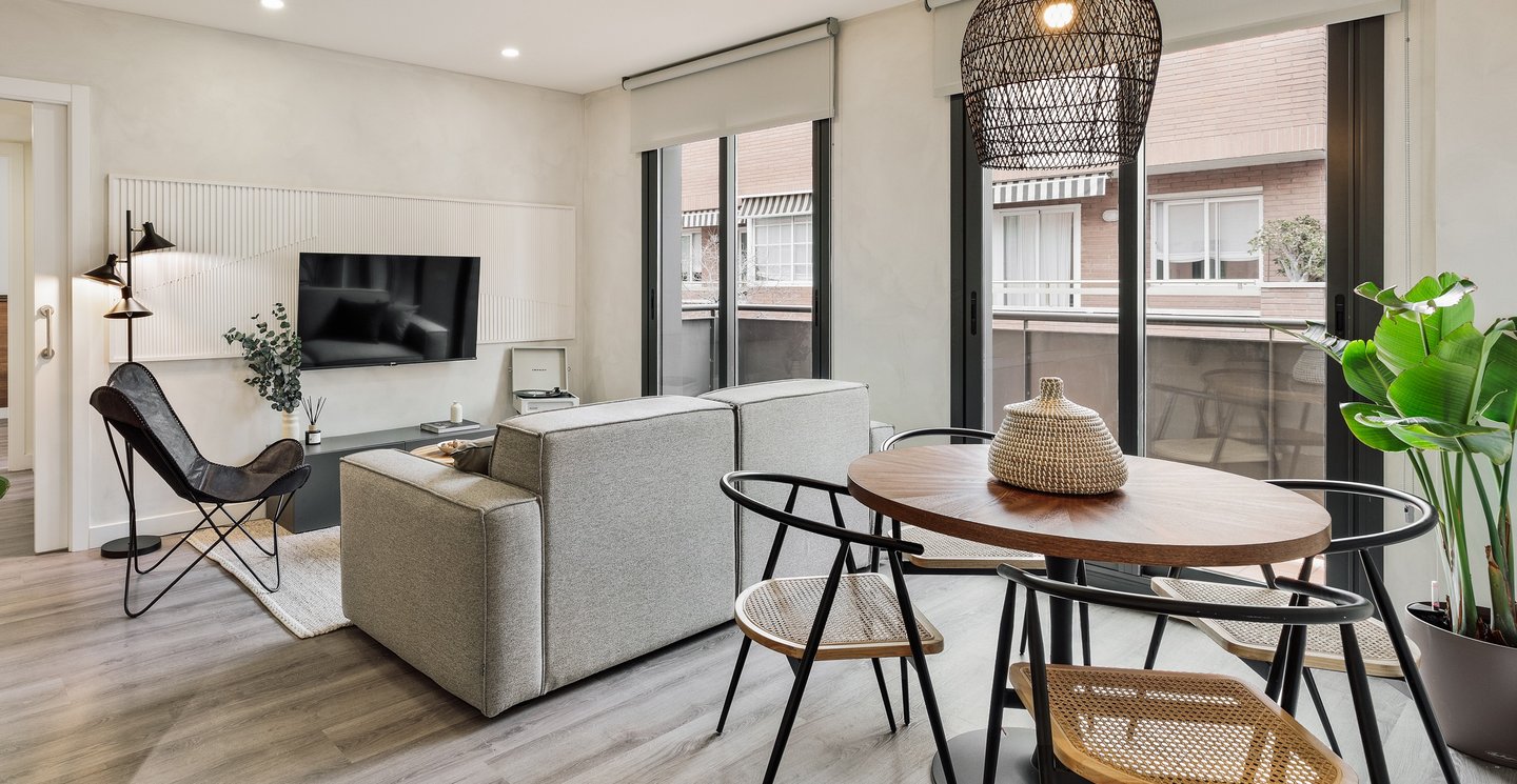 Bright living room with contemporary interior design, bespoke wall panels and black metal accents