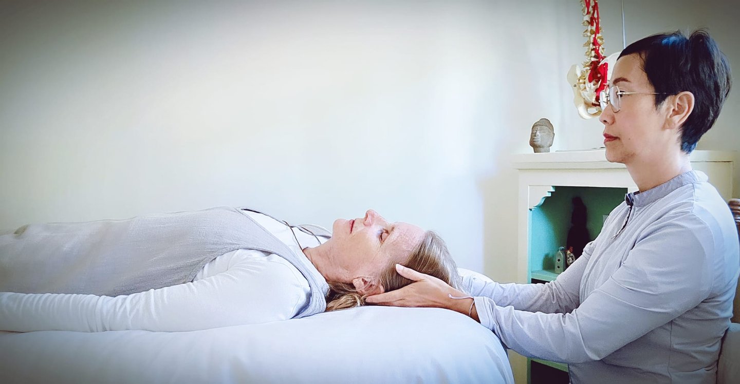 Denise with hands on client's head