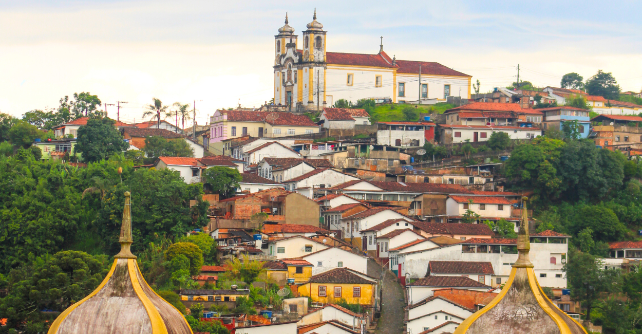 Igreja histórica e casas em uma ladeira na cidade turistica de Ouro Preto, em Minas Gerais