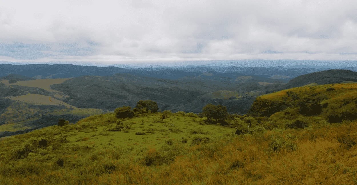 Paisagem montanhosa de Itambé do Mato Dentro MG com vales verdes, morros e céu nublado