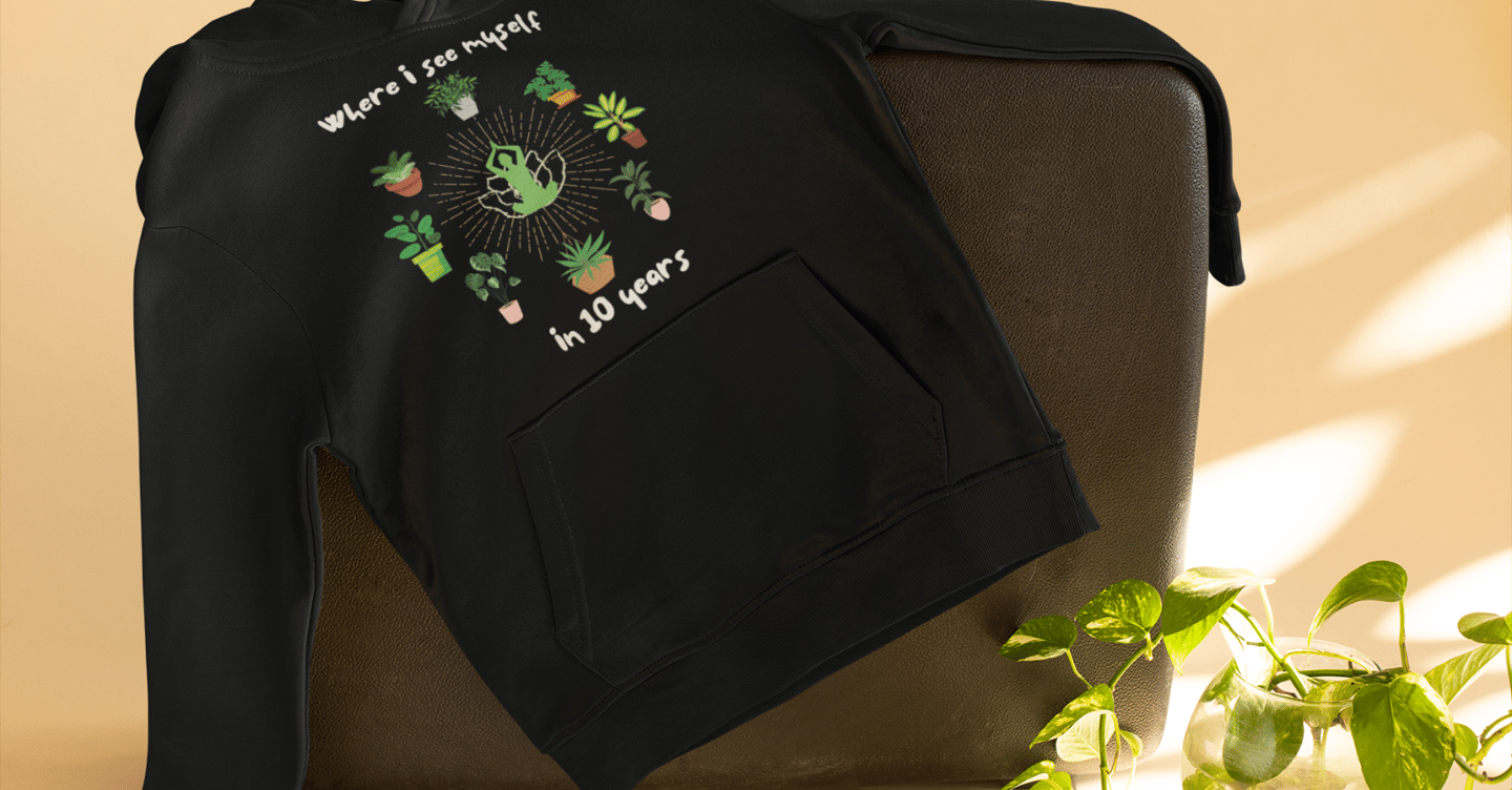 Cozy black hoodie with playful plant illustration — plant-lover sweatshirt from Miss Chatty Plants.