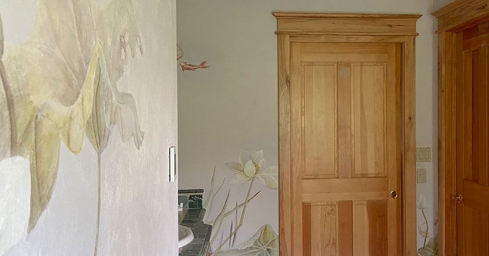 Luxury bathroom featuring painted murals of water lilies, koi and dragonflies in  watercolour and an Asian touch