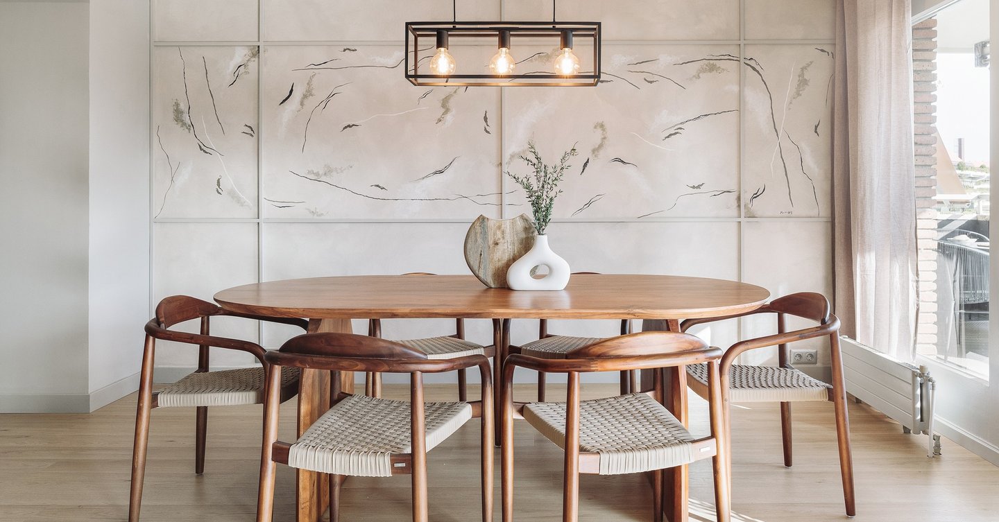Modern dining area with metal light fixture, wooden dining table and minimalist design in Barcelona