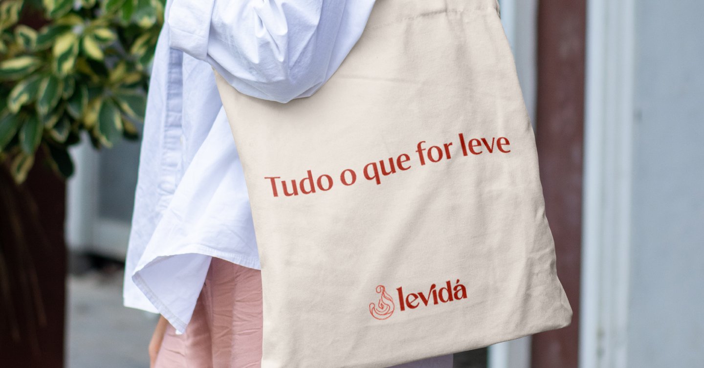 a woman in a white shirt and pink pants with a baguet bag