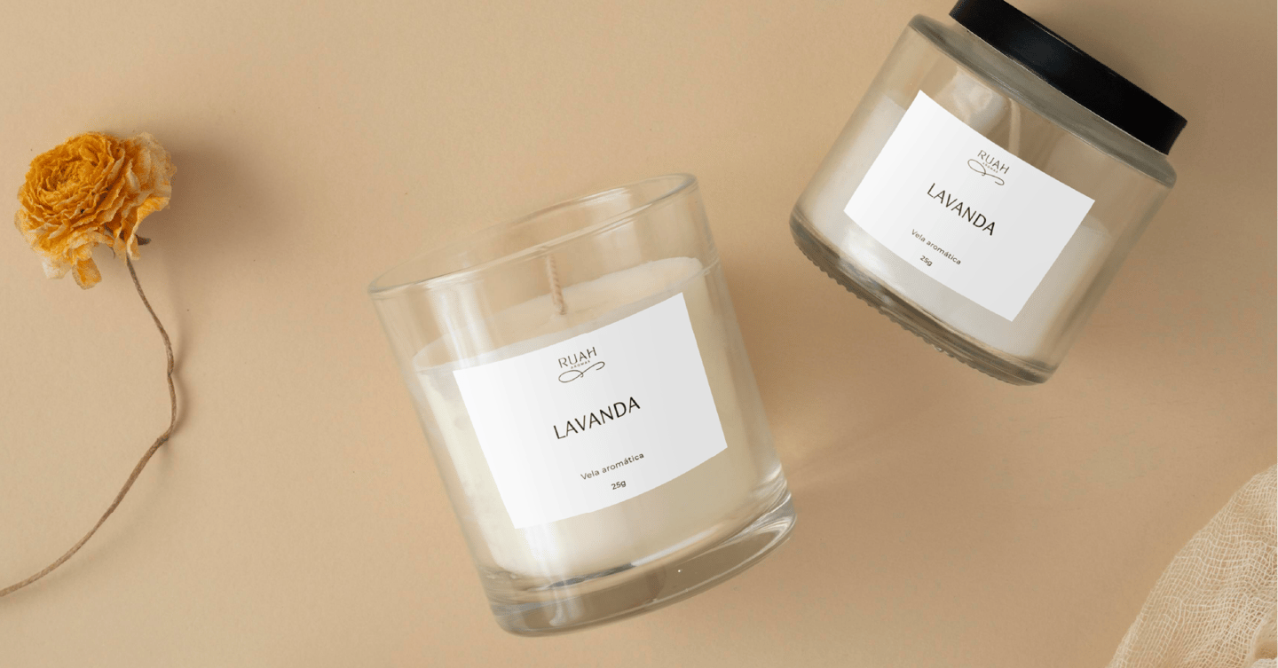 a candle with a flower on a table