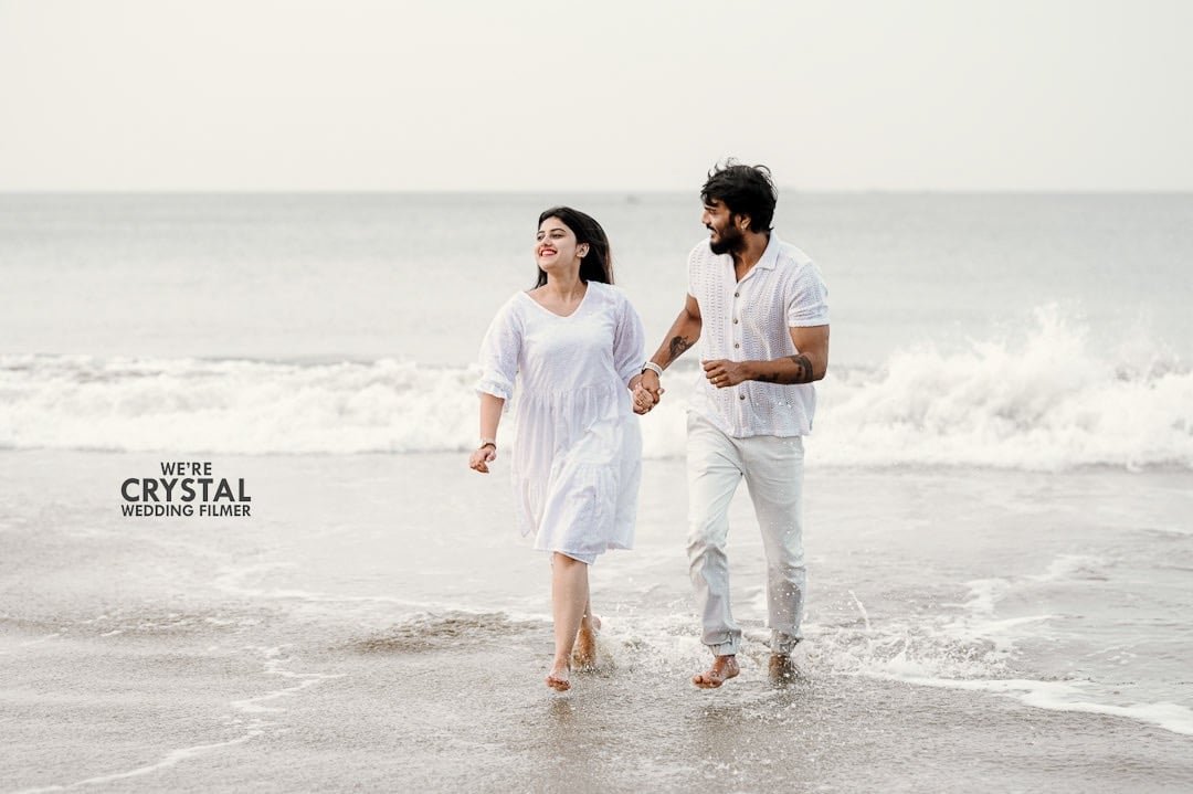 Couples in white costumes on beach for pre wedding photography in kerala