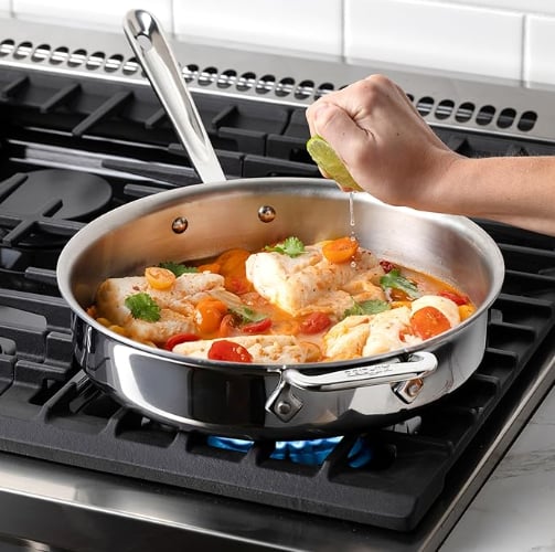 Healthy food searing in a stainless steel pan on a modern stovetop